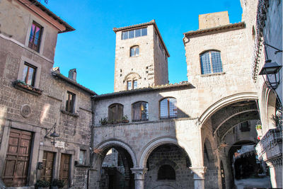 Low angle view of old building against blue sky