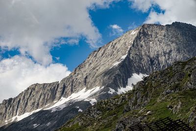 Low angle view of snowcapped mountains against sky