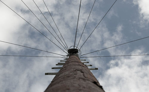 Low angle view of telephone pole against sky