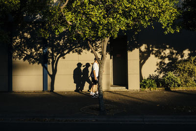 Woman standing on tree trunk