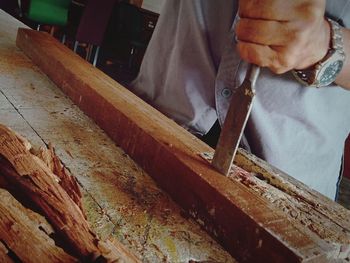 Midsection of man working on table