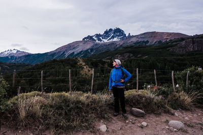 Full length of man standing on mountain against sky