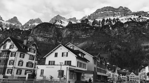 View of houses against mountain range