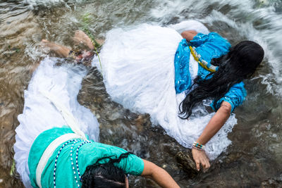 Two faithful candomble women bathe in the sea during the festival in honor of iemanja.