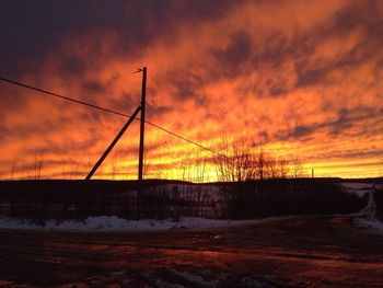 Snow covered landscape at sunset