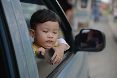 Close-up of baby girl in car