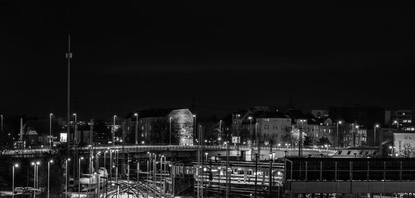 Illuminated cityscape against sky at night