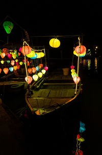 Illuminated lanterns hanging in restaurant at night