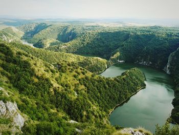 High angle view of lake amidst cliffs