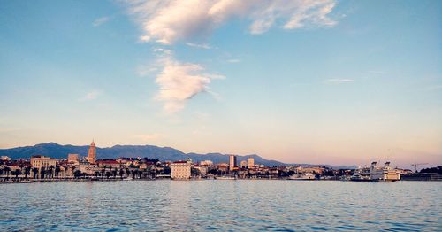 View of city by sea against sky