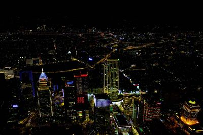 High angle view of illuminated city buildings at night