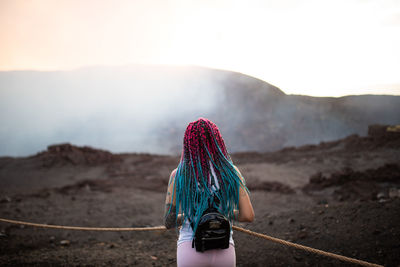 Rear view of woman walking on mountain