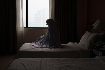 Man relaxing on bed in house