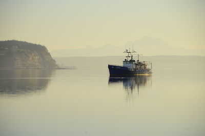 Boat moored in sea against clear sky