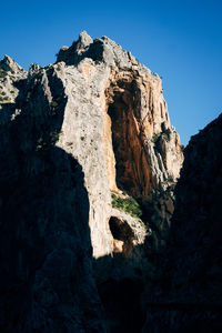 Low angle view of rock formation against clear sky