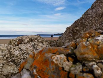 Scenic view of rocks on beach against sky