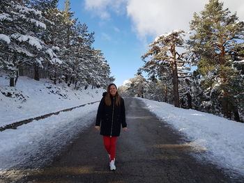 Full length of woman on snow covered field