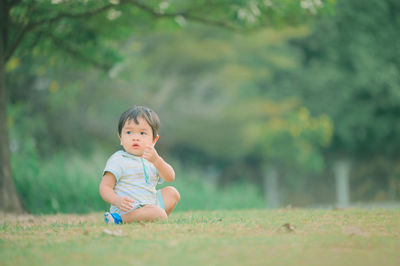 Portrait of cute baby girl on field