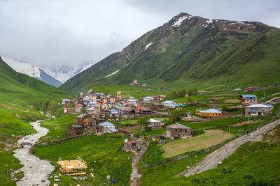 Scenic view of village amidst buildings against sky