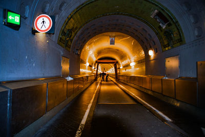 Man walking in illuminated elbe tunnel