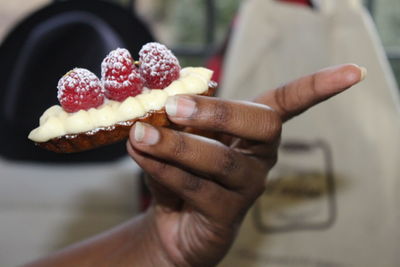 Close-up of hand holding ice cream