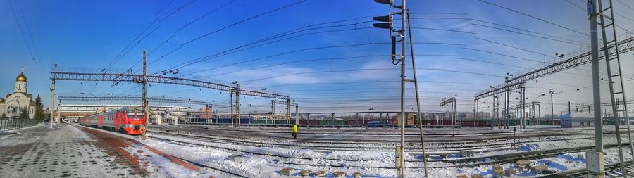 Railroad tracks against sky during winter