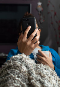 Midsection of woman using mobile phone