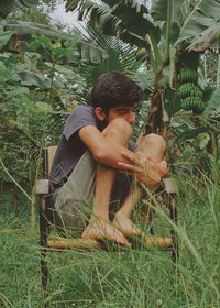 Young man sitting on field