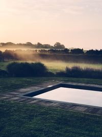 Scenic view of field against sky during sunset