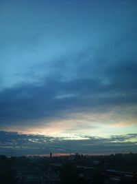 Cityscape against cloudy sky