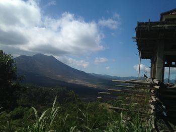 Scenic view of mountains against cloudy sky