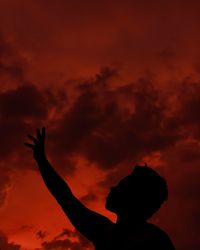 Silhouette person against sky during sunset