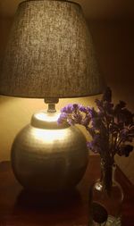 Close-up of illuminated lamp on table at home