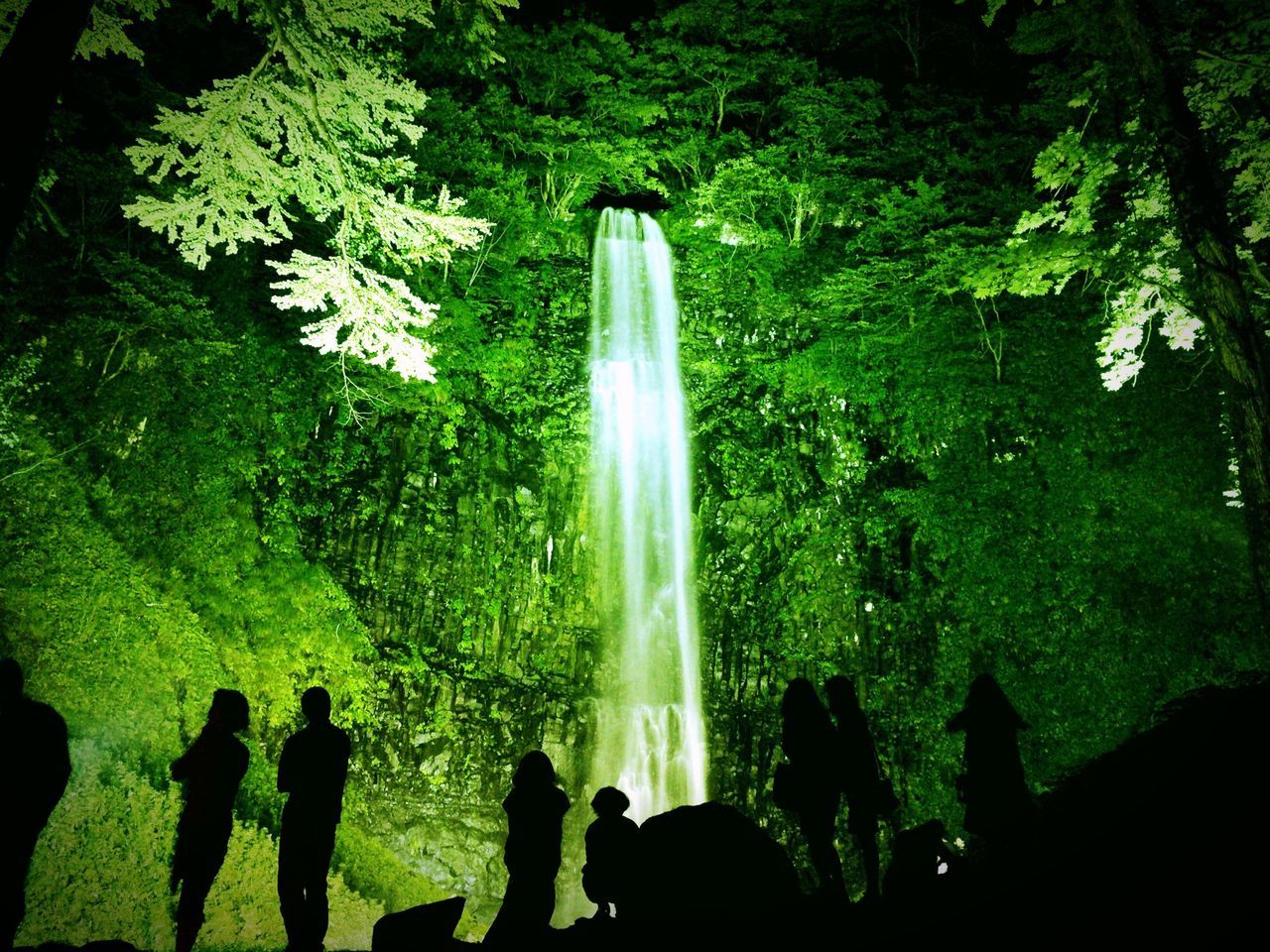 motion, water, waterfall, large group of people, long exposure, fountain, flowing water, nature, tree, spraying, men, beauty in nature, outdoors, blurred motion, forest, green color, splashing, day, person