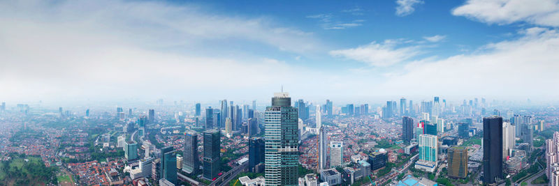 Aerial view of modern buildings in city against sky