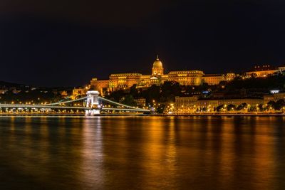 Szechenyi chain bridge over danube river in city at night