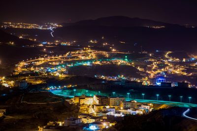 High angle view of illuminated buildings in city at night