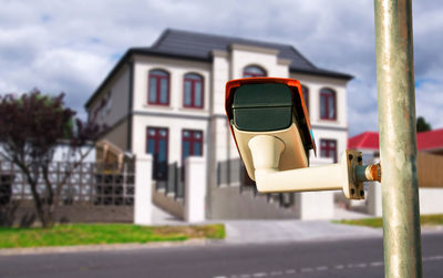 Close-up of cars on road against buildings