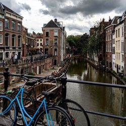 Canal amidst buildings against sky