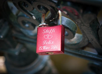 Close-up of love padlock on metallic fence