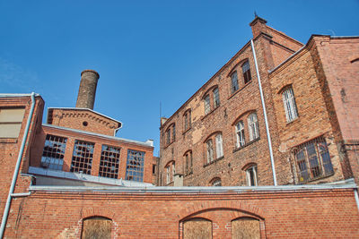 Low angle view of building against blue sky