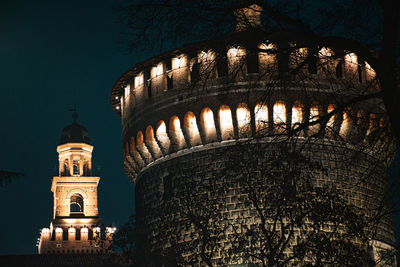 Low angle view of illuminated building against sky at night