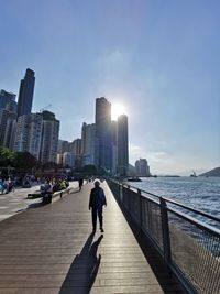 Rear view of woman walking on promenade