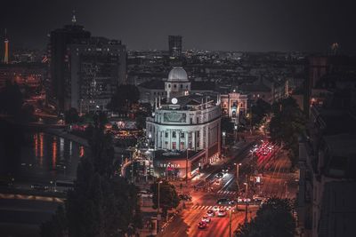 High angle view of city lit up at night