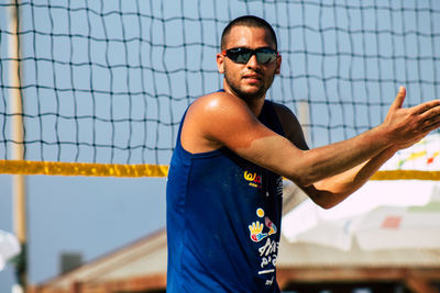 Portrait of young man wearing sunglasses standing outdoors