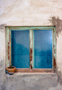 Old window with the clay pot