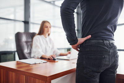 Midsection of businessman working at office