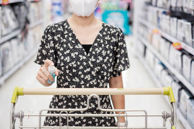 Midsection of woman standing in store