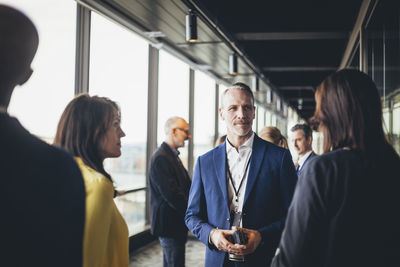 Businessman standing with female colleagues in office