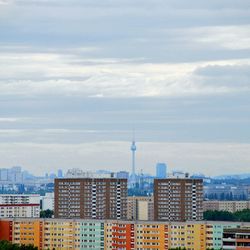 Cityscape against cloudy sky